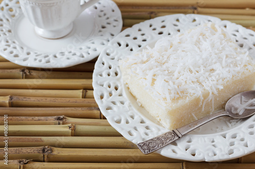 Sweet couscous pudding (cuscuz doce) coconut on vintage plate