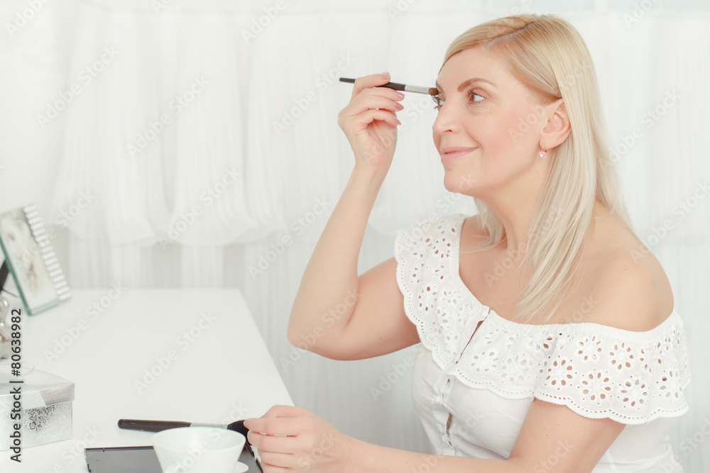 Make-up before the mirror at home