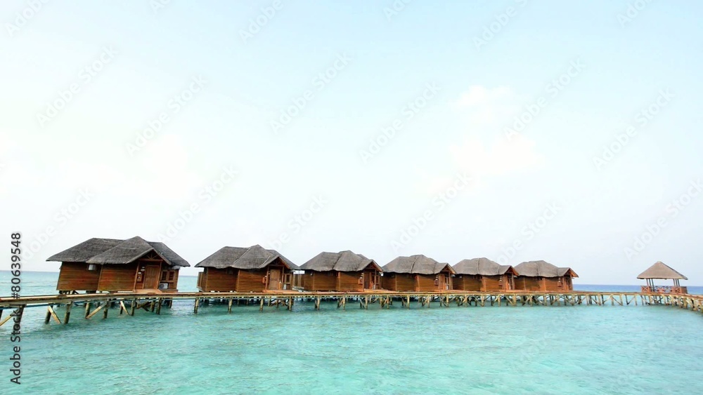 Over water bungalows with steps into amazing green lagoon Over water bungalows with steps into amazing green lagoon
