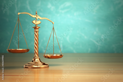 Concept of justice. Law scales on green background.