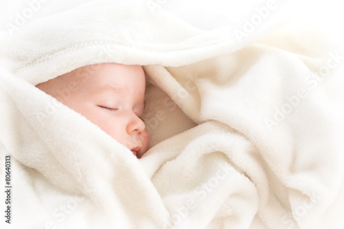 Baby sleeping covered with soft blanket photo