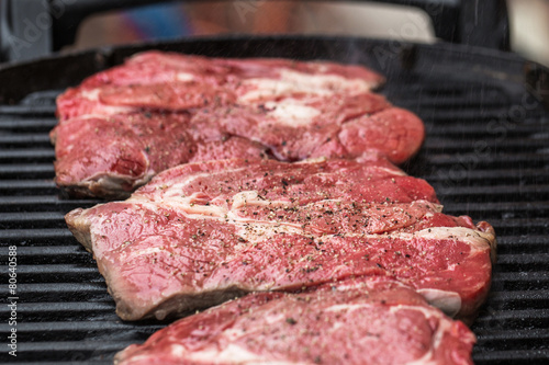 Fresh beef steaks on grill or BBQ
