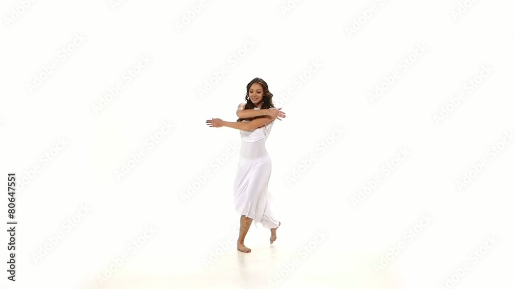 Young, attractive and slim woman in light dress dancing contemp Young, attractive and slim woman in light dress dancing contemp