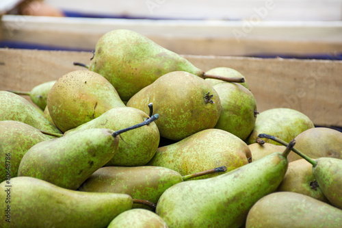 bio pears in a wooden box at the farmers market