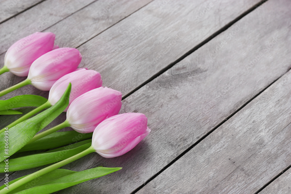 Beautiful pink tulips on wooden planks background Beautiful pink tulips on wooden planks background