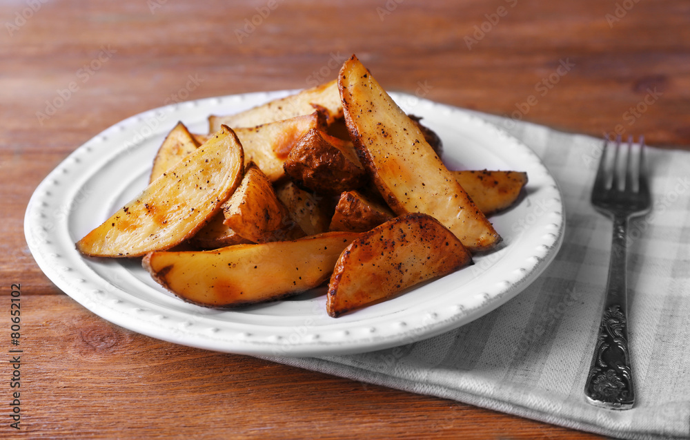 Baked potatoes on pate on wooden table Baked potatoes on pate on wooden table