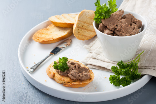 Chicken liver pate on bread and in bawl