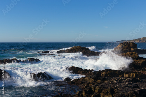 Ocean waves breaking on shoreline rocks