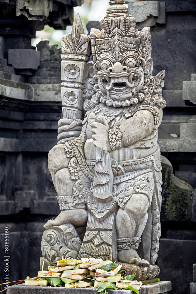 Statues and carvings depicting demons or gods with offerings