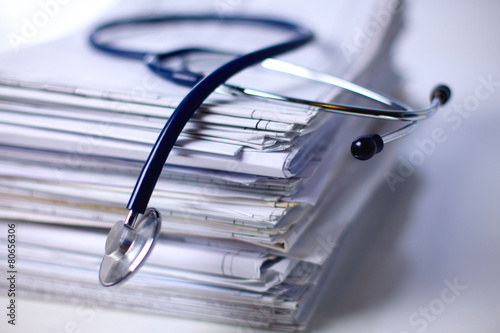 Medical stethoscope on the stack of paper