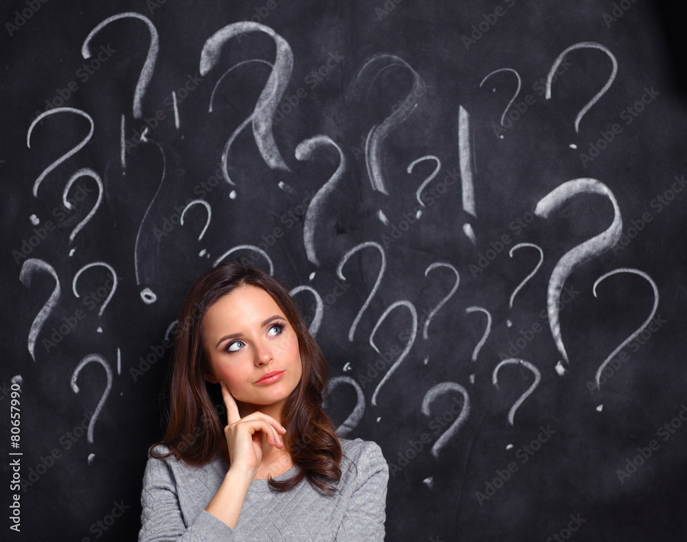 Young girl with question mark on a gray background Young girl with question mark on a gray background