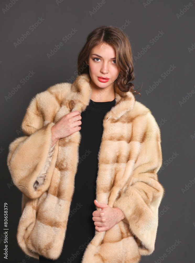 Portrait of a beautiful woman in jacket with fur. Portrait of a beautiful woman in jacket with fur.