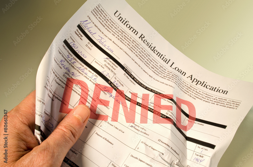 Naklejka premium Denied loan application crumpled in hand