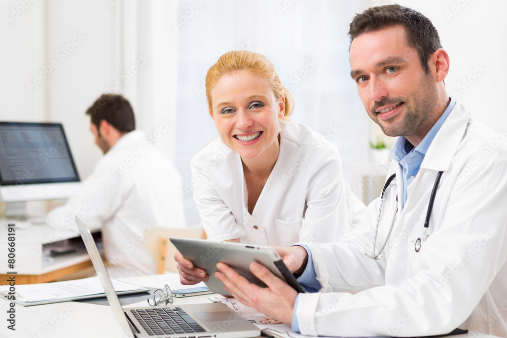 Doctor and an assistant working together at the hospital Doctor and an assistant working together at the hospital