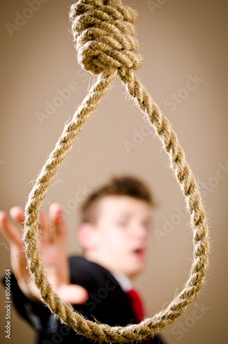 man in suit with hanging noose photo