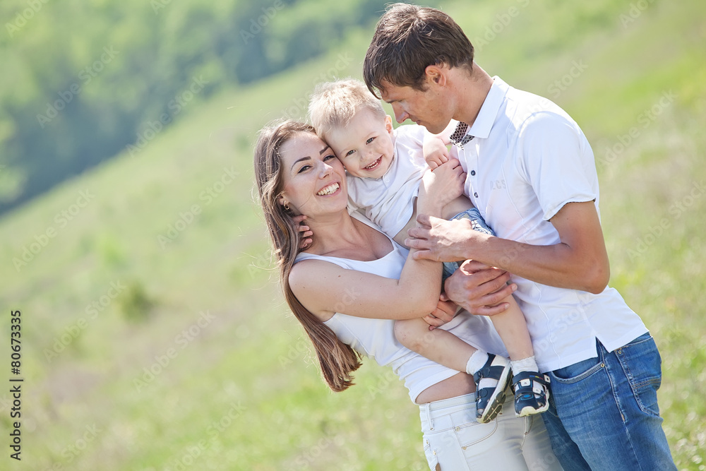 Family playing with son in the flowers field Family playing with son in the flowers field