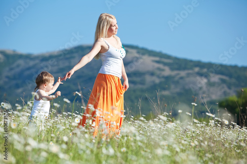 mother with son in a flowers field photo