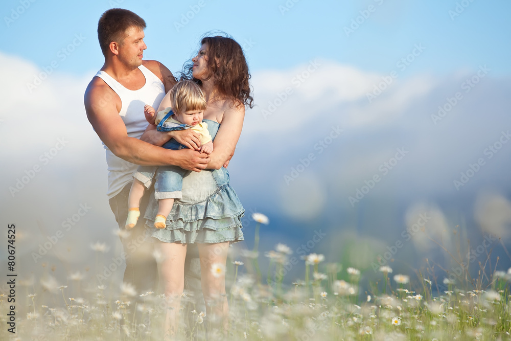 Happy family in flowers field