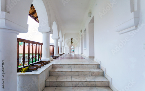 Arched colonade hallway at Sambata de Sus monastery in Transylva