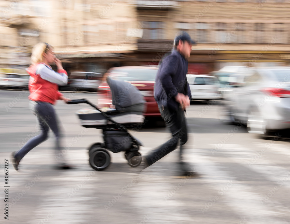 Fototapeta premium Family with stroller on zebra crossing