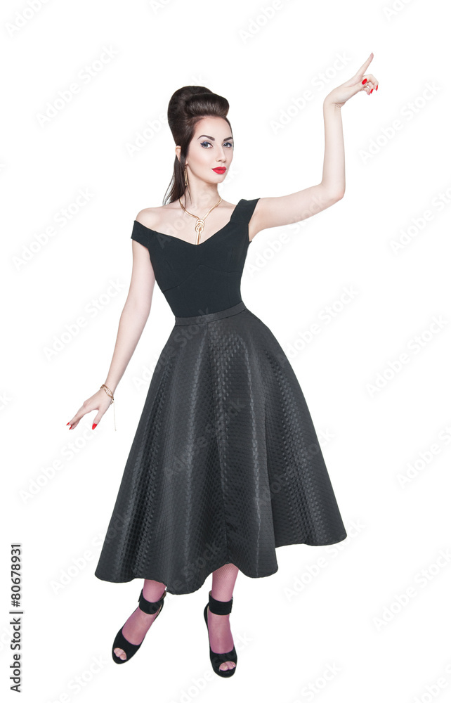 Naklejka premium Young beautiful woman in retro pin up style showing on something