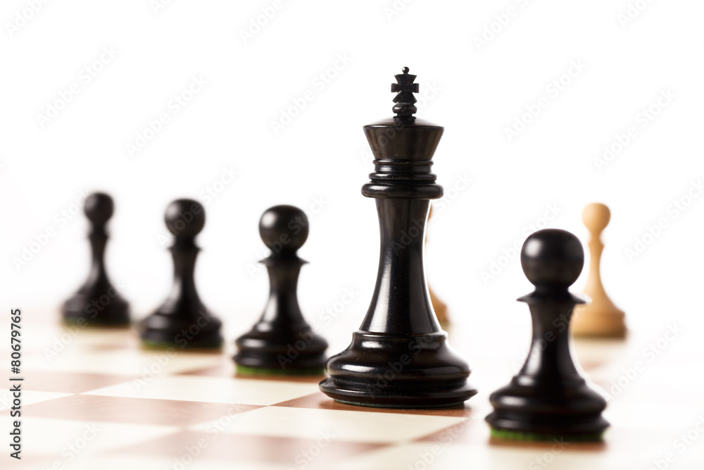 Black chess pieces on a chessboard standing in perspective Black chess pieces on a chessboard standing in perspective