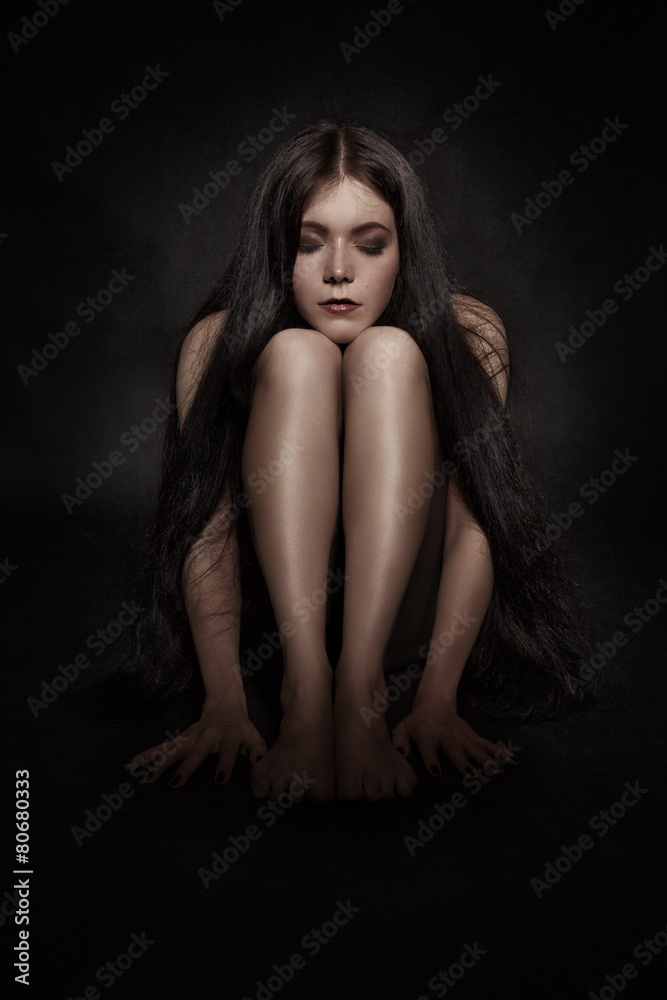woman sitting in dark woman sitting in dark