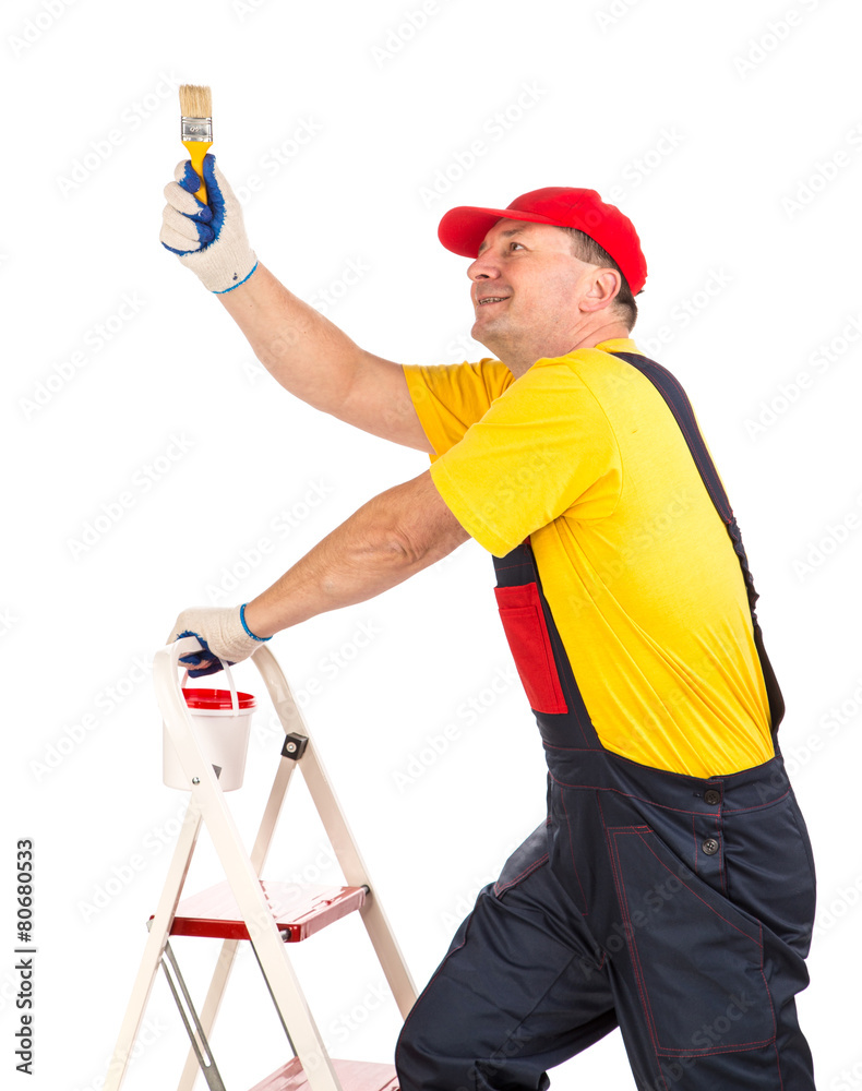 Worker on ladder with brush. Worker on ladder with brush.