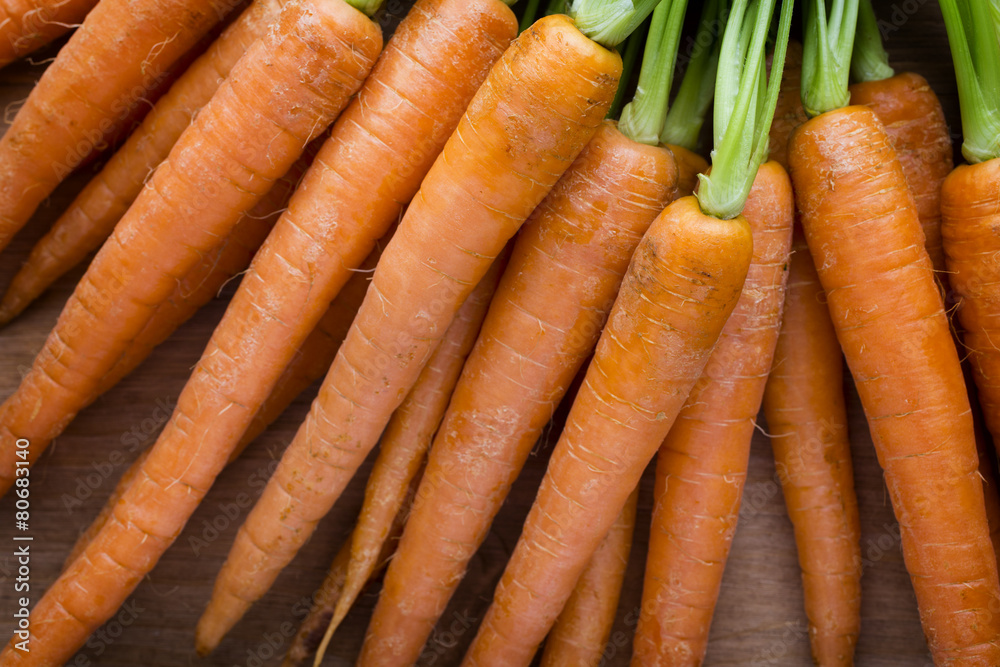 Fresh carrots on the wooden background. Fresh carrots on the wooden background.