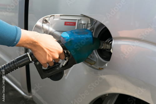 Men hold Fuel nozzle to add fuel in car at gas station © Noey smiley
