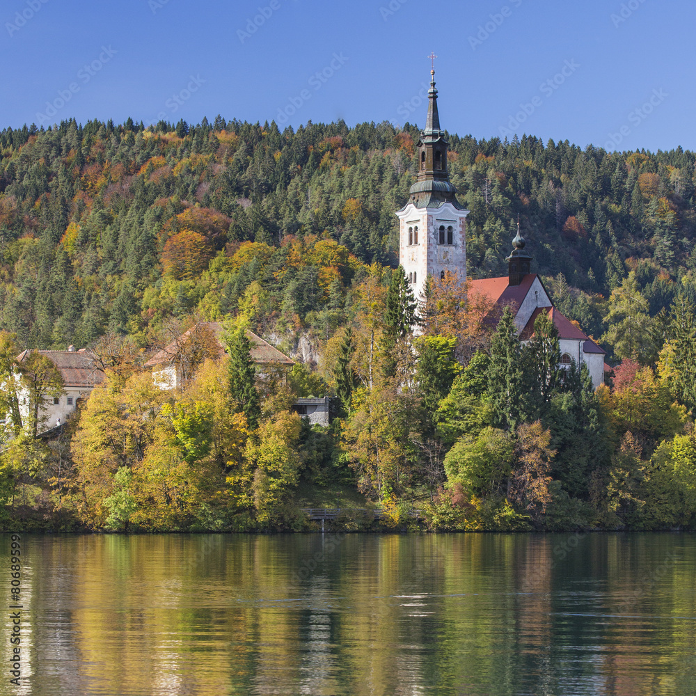 belfry and reflection on the lake in Slovenia