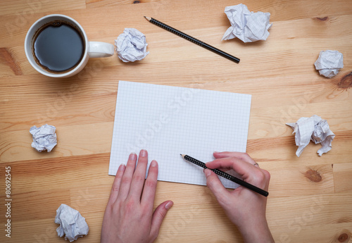 Blank notepad with pencil and coffee on wooden desk