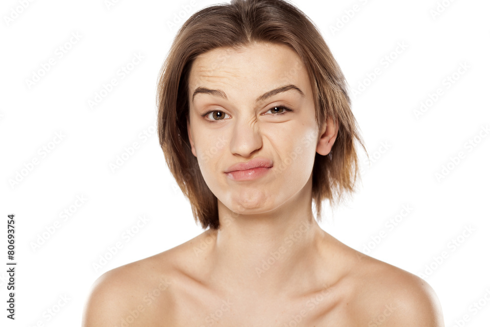 young beautiful woman with a suspicious gesture young beautiful woman with a suspicious gesture