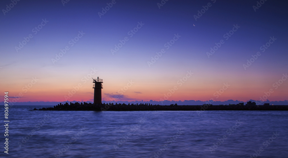 Lighthouse on sunset.dramatic sky lights