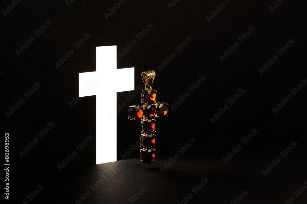 Obraz premium Golden Cross with gemstone jewel on black background