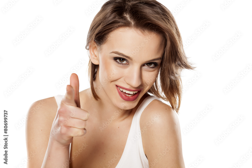 happy young beautiful girl pointing a finger at you happy young beautiful girl pointing a finger at you