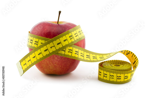 Red apple with measuring tape isolated on white background