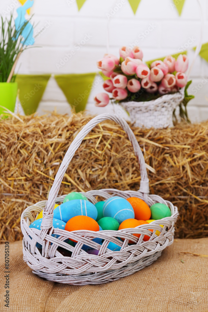 large basket with colored eggs