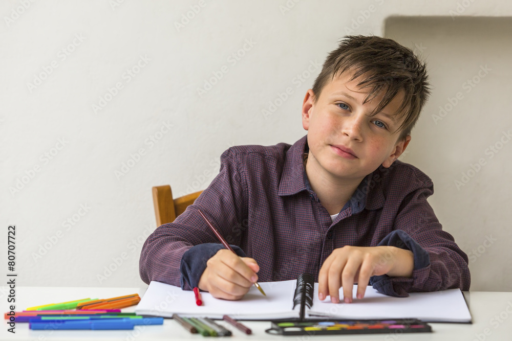 School boy doing homework at his desk. School boy doing homework at his desk.