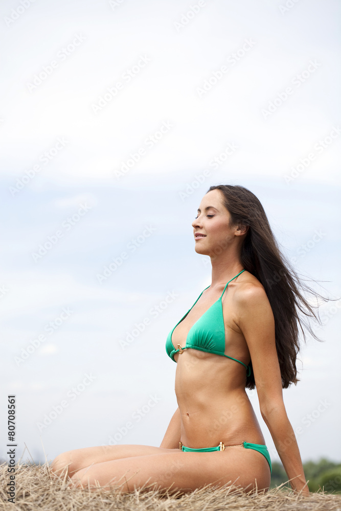 Young slim model in a green bikini Young slim model in a green bikini