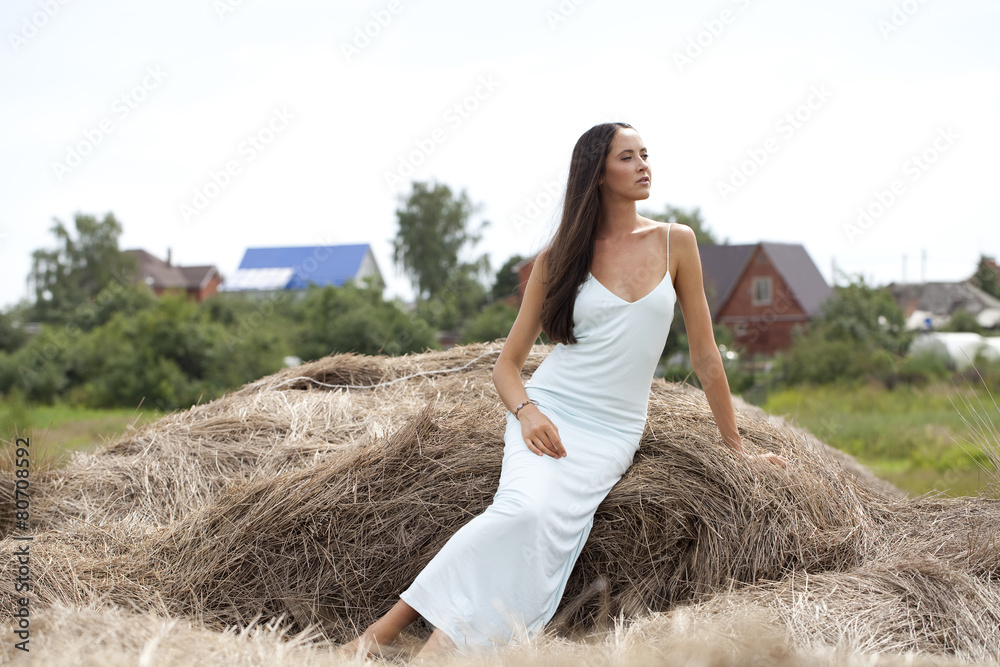 Young beautiful woman in the hayloft in the village Young beautiful woman in the hayloft in the village