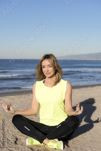 Young woman making exercise on the beach