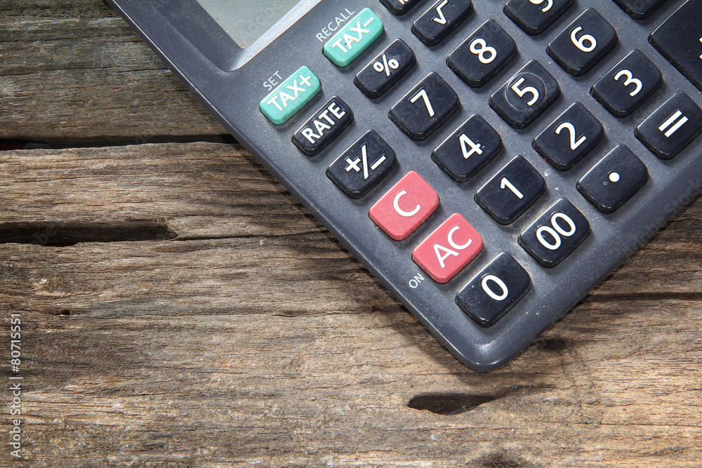 Calculator on old wood background.