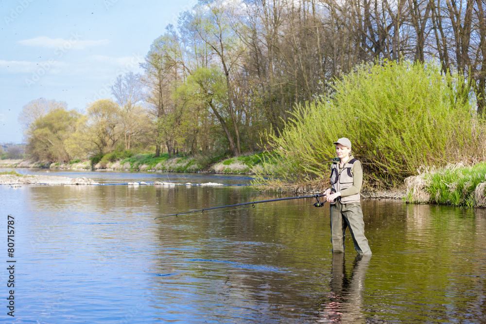 woman fishing in the river in spring woman fishing in the river in spring
