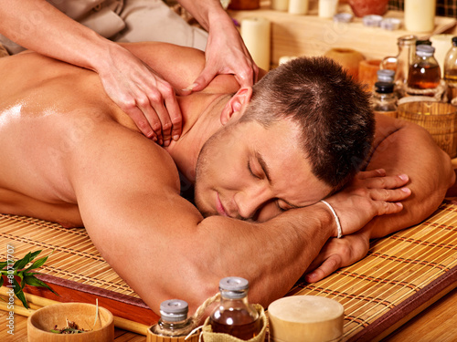 man getting bamboo massage.