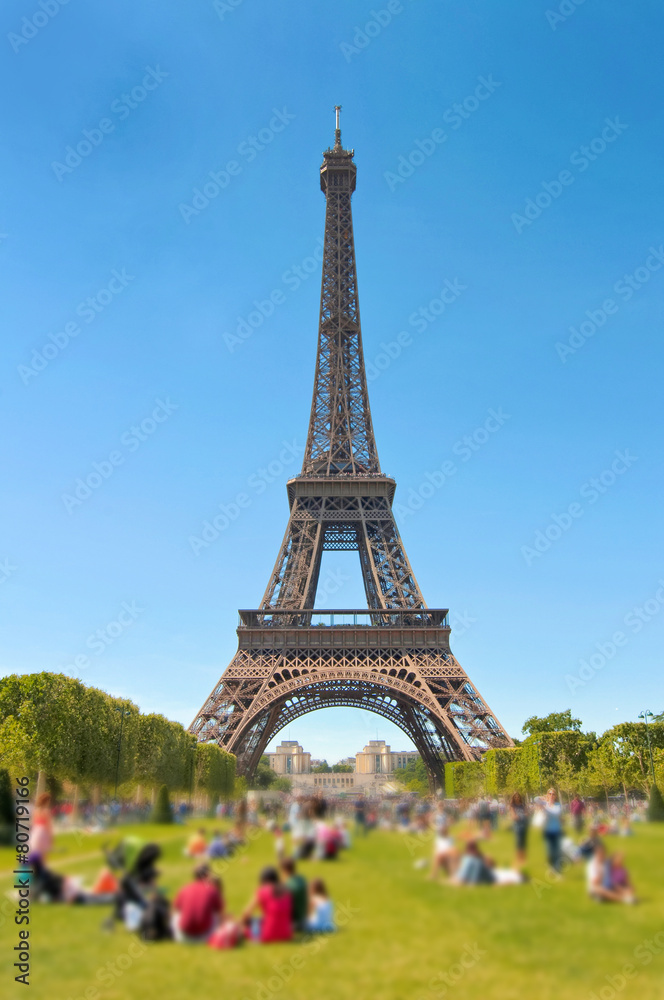 People relaxing on the Champ de Mars, Eiffel tower, Paris,