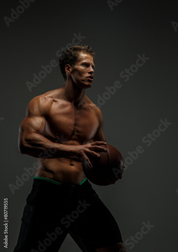 Muscular male with basket  ball