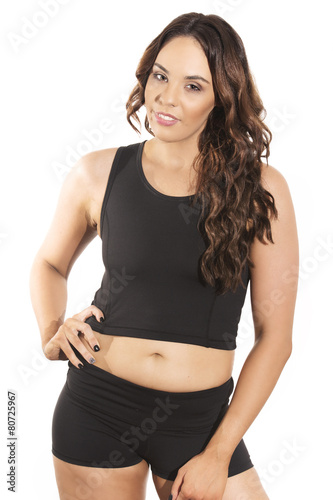 Young female fitness model posing in studio.