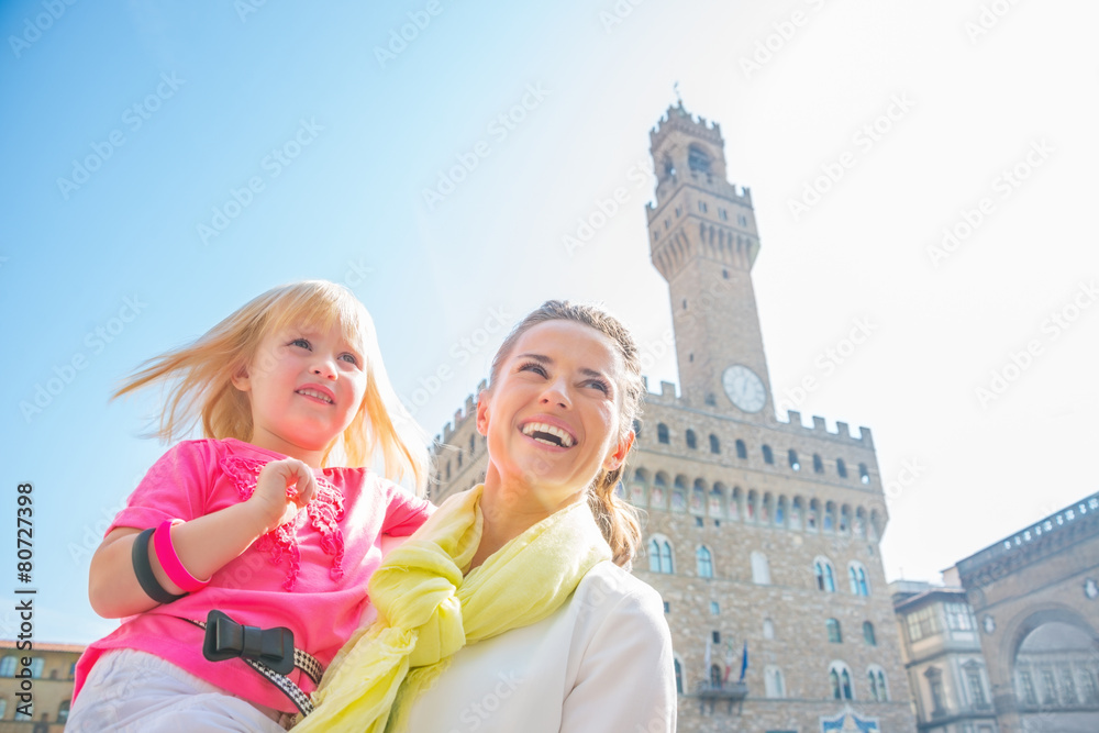 Happy mother and baby girl in florence, italy