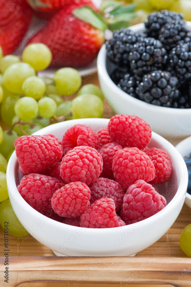 bowl of raspberries, fresh berries and green grapes bowl of raspberries, fresh berries and green grapes